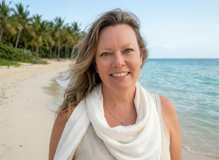Woman smiling at camera on tropical beach with palm trees and turquoise water in background